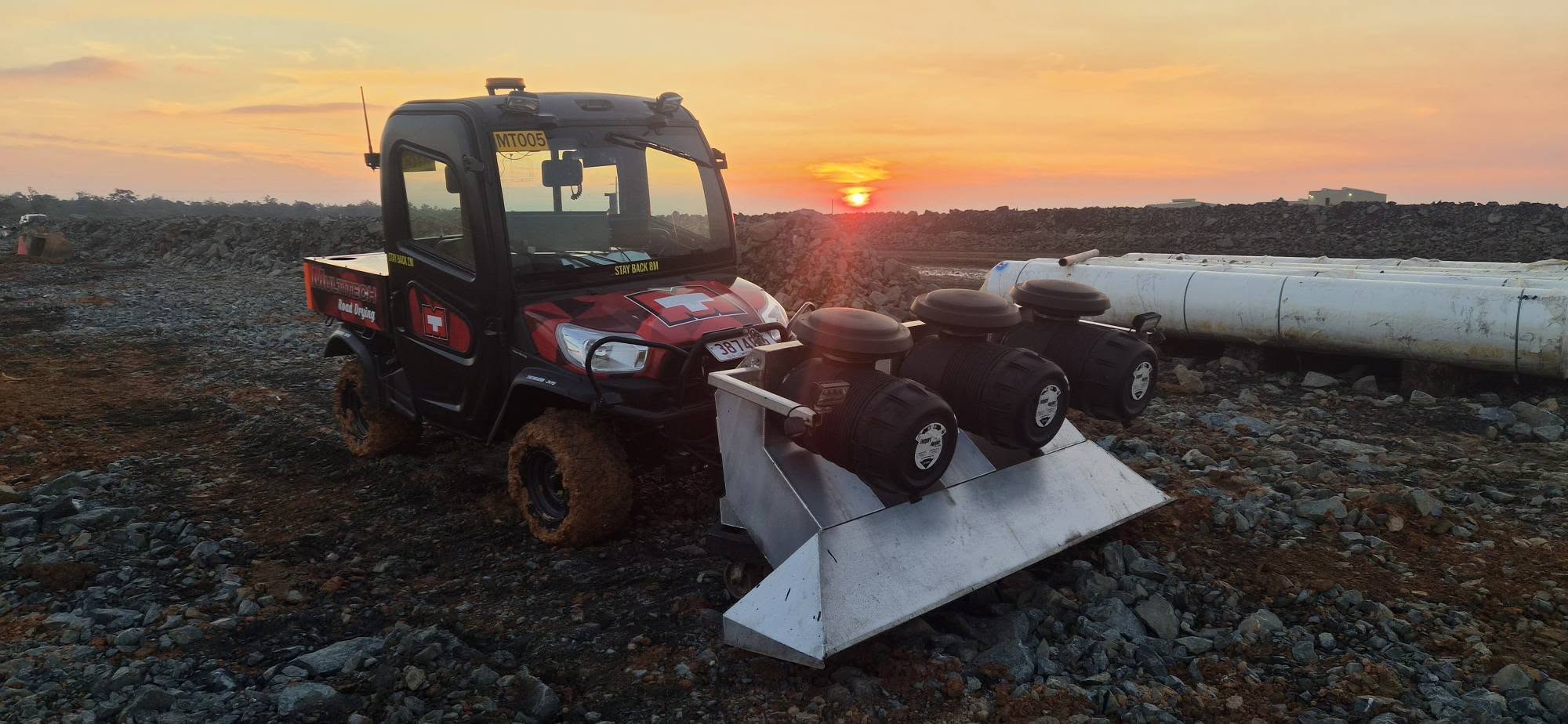 Multitech road dryer and jet head on a rock haul pad at sunset
