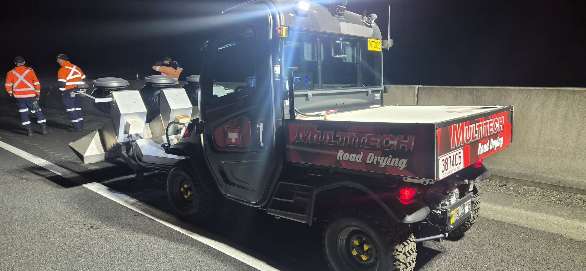 Multitech Road Drying machine and crew on a motorway at night